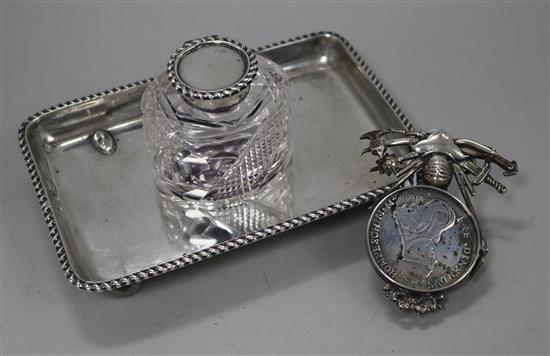 A late Victorian silver inkstand with single well and a white metal ornate menu holder, inset with coin.